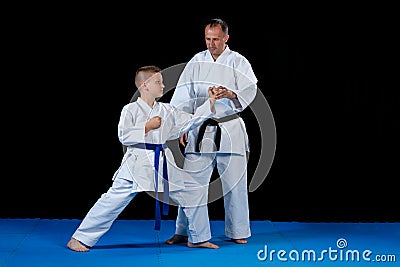 Male karate instructor training little children in dojo Stock Photo