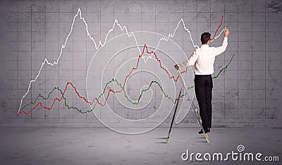 Male on ladder drawing chart lines Stock Photo