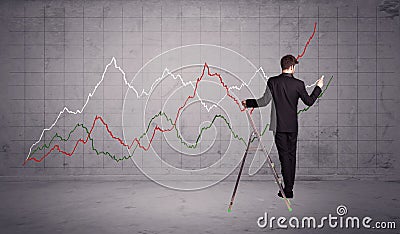 Male on ladder drawing chart lines Stock Photo