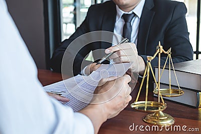 Male lawyer discussing negotiation legal case with client meeting with document contact in courtroom, law and justice concept Stock Photo