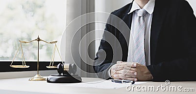 Male lawyer or judge sits and analyzes the case and decides the case with fairness Stock Photo