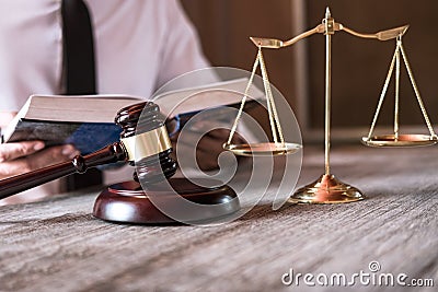 Male lawyer or judge working with Law books, gavel and balance, report the case on table in office, Law and justice concept Stock Photo