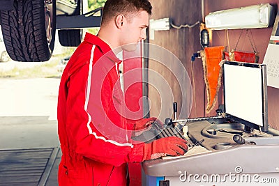 Male mechanic checking the readout on a computer Stock Photo