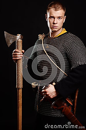 Male medieval warrior in armour and chain mail, viking with batt Stock Photo