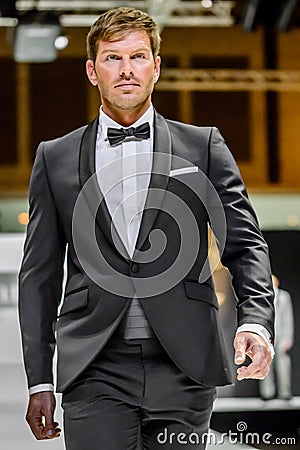 Male model on catwalk wearing bridegroom suit Editorial Stock Photo