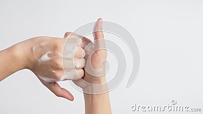 Male model is interlock fingers and rub mid-joints with foaming hand soap on white background Stock Photo