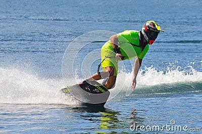 Male Motosurf Competitor Taking corner at speed creating a lot of spray. Editorial Stock Photo