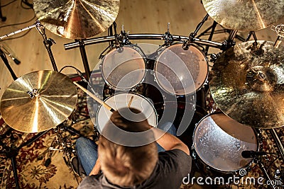 Male musician playing drums and cymbals at concert Stock Photo