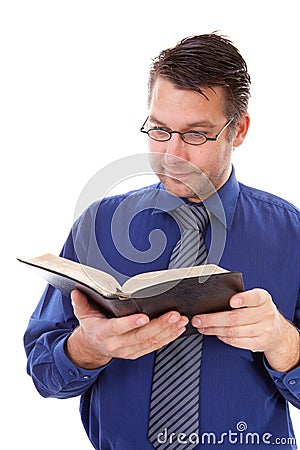Male nerdy geek is reading a book Stock Photo