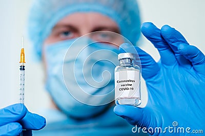 Male Nurs holding vaccine bottle with Coronavirus vaccine Stock Photo