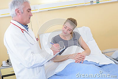 Male nurse inspecting pregnant patient Stock Photo