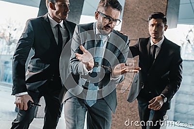 male offender showing security guards shrug Stock Photo