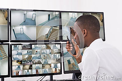 Male Operator Talking On Walkie-Talkie Stock Photo