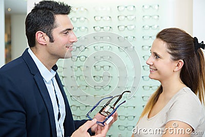 Male ophthalmologist and female patient in optics store Stock Photo
