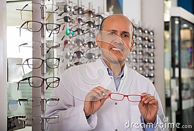 Male ophthalmologist standing near eye chart Stock Photo