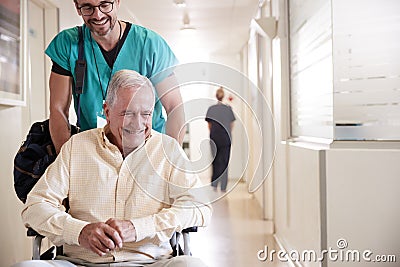 Male Orderly Pushing Senior Male Patient Being Discharged From Hospital In Wheelchair Stock Photo