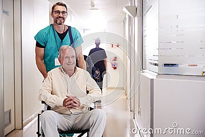 Male Orderly Pushing Senior Male Patient Being Discharged From Hospital In Wheelchair Stock Photo