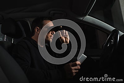 male paparazzi with smartphone in hand doing surveillance by binoculars from Stock Photo