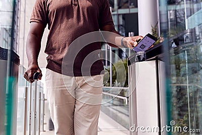 Male Passenger In Airport Departure Lounge Scanning Digital Boarding Pass On Smart Phone Stock Photo
