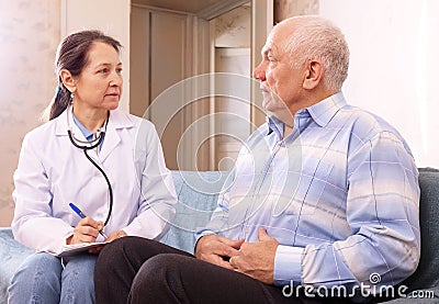 Male patient complaining of pain in side to docto Stock Photo