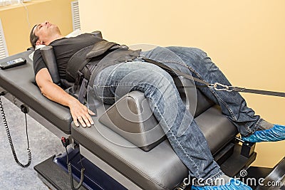 Male patient at non-surgical treatment physiotherapy of lumbar spine and spinal cord dilatation in medical center Stock Photo