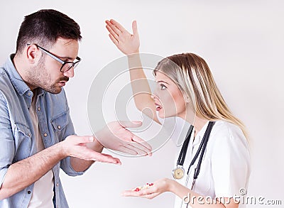 Man rejecting spoon with pills from doctor Stock Photo
