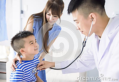 Male pediatrician hold stethoscope exam child boy patient visit doctor with mother Stock Photo