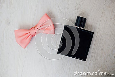 Male perfume and pink bow tie Stock Photo