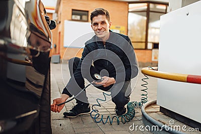 Male person checks the tire pressure, tyre service Stock Photo