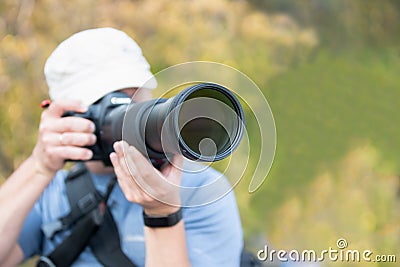 Male person with long telephoto lens Editorial Stock Photo