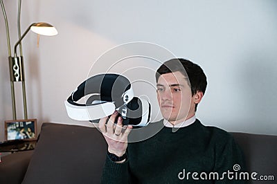 Male person looks at virtual reality headset Stock Photo