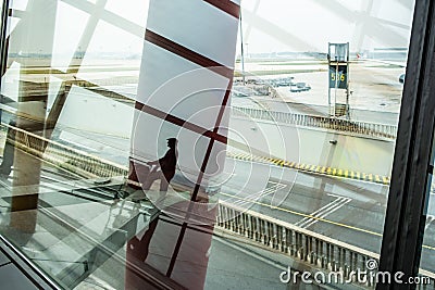 Male person silhouette reflecting in Airport terminal window. Editorial Stock Photo