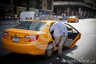 Male person taking a yellow cab Editorial Stock Photo