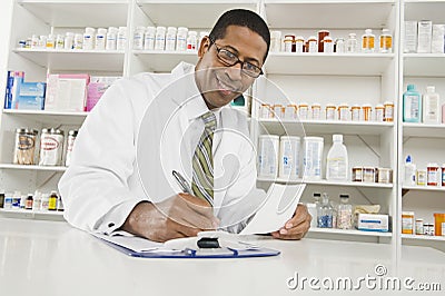 Male Pharmacist Working In Pharmacy Stock Photo