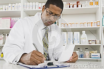 Male Pharmacist Working In Pharmacy Stock Photo