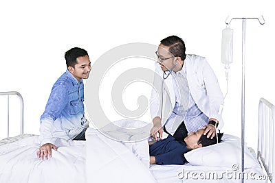 Male physician examines a little boy on studio Stock Photo