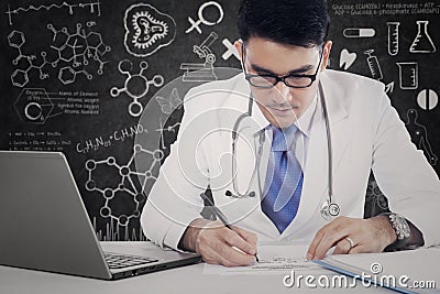 Male physician makes medicine recipe Stock Photo