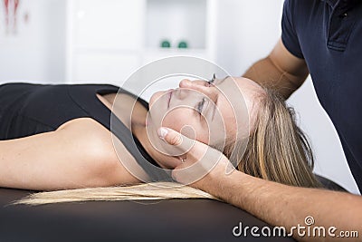 Male physio therapist and woman helping patient Stock Photo