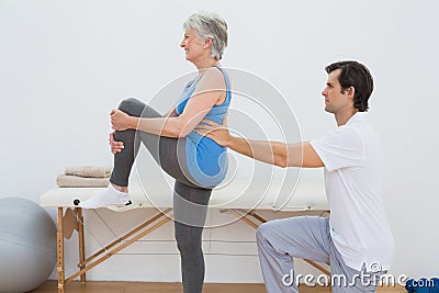 Male physiotherapist examining senior womans back Stock Photo