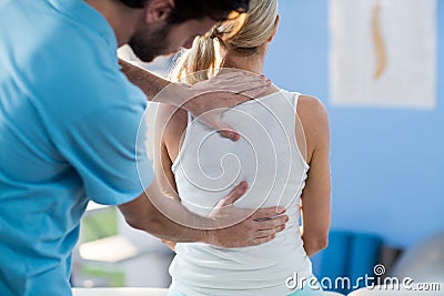 Male physiotherapist giving back massage to female patient Stock Photo