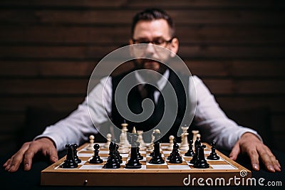 Male player against chess board with pieces set Stock Photo