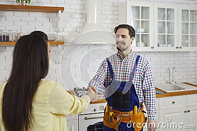 Male plumber handshake satisfied female client Stock Photo