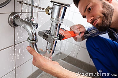 Plumber Repairing Sink Pipe Leakage Stock Photo