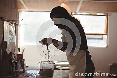 Male potter washing hands after working on pottery wheel Stock Photo