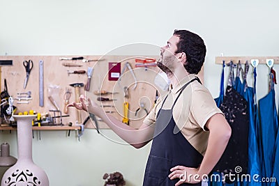 Male Potter in Workshop Posing Against Instruments panel Stock Photo