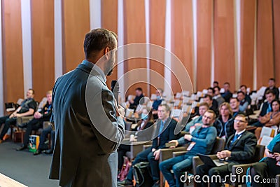 Male presenter speaks to audiences at seminar Editorial Stock Photo