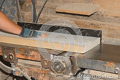 Male Production Workshop Worker Hand Grinding Wooden Board Plank Machine Tool Industrial Equipment Stock Photo