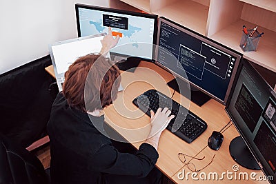 Male programmer working on desktop computer with many monitors at office in software develop company. Website design Stock Photo