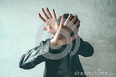 Male protecting face from violent attack Stock Photo