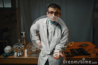 Male psychiatrist in lab coat shows sedative pills Stock Photo